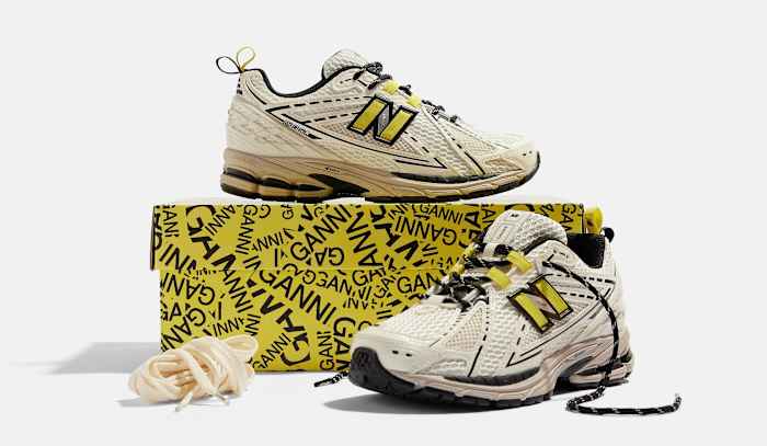 Side view of egret and black New Balance shoes.